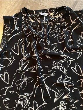 Reitmans Black Sleeveless Camisole with White pattern. Pleated split neck.